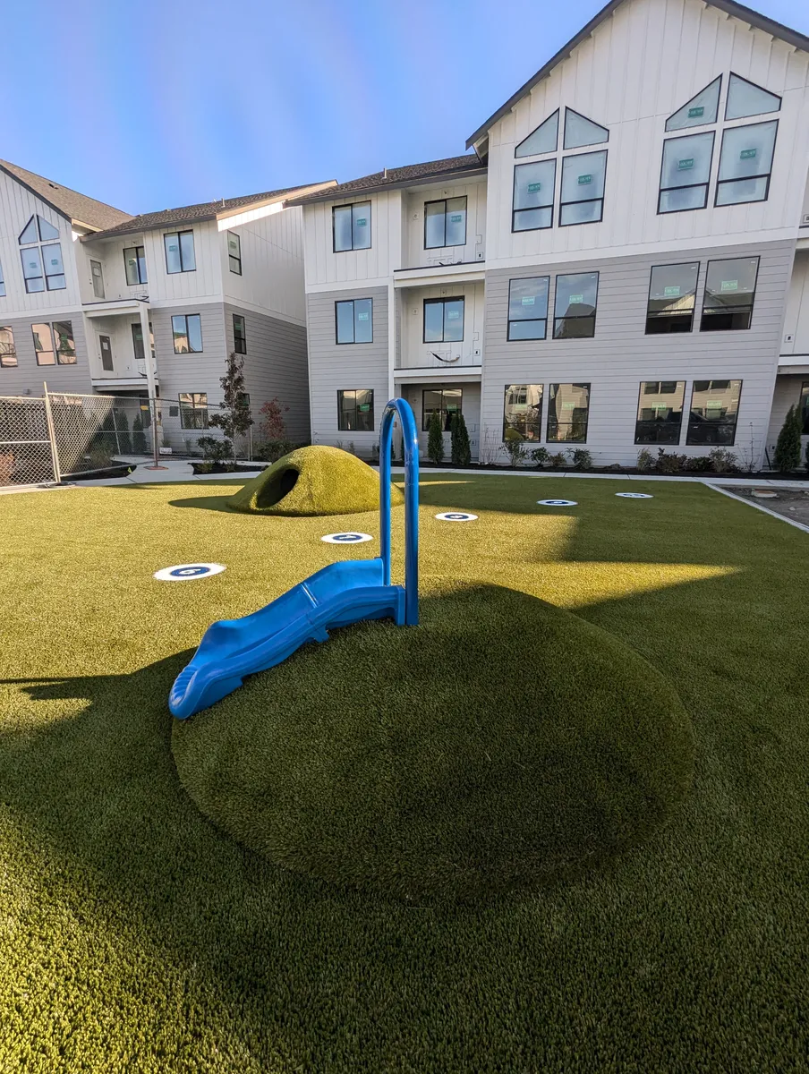 artificial grass covered mounds for play